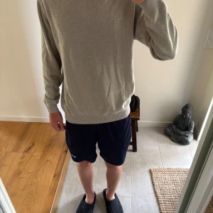 Oscar Jacobson Kashmir mix beige M (pris diskuteras) - Säljer en stilren beige stickad tröja med rund hals och långa ärmar. Tröjan har ribbade muddar vid ärmslut och nederkant, vilket ger en snygg och enkel look. Perfekt för dig som gillar en clean och avslappnad stil.