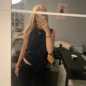 Mörkblå spetsblus med volangdetaljer - Säljer en mörkblå blus med spets och volangdetaljer vid ärmslut och hals. Den är genomskinlig i ryggen, hittar ingen prislapp men tror XS. Pris går att diskutera 