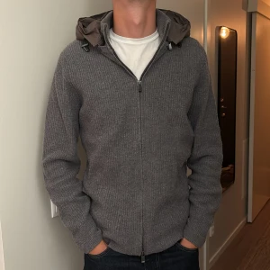 Grå stickad cardigan jacka med huva - Kofta ifrån Massimo dutti, säljs inte längre! Sparsamt använd. Storlek M men passar S också. 