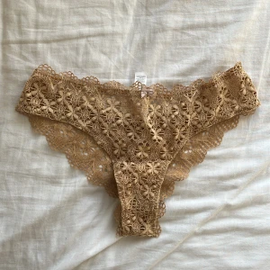 Brazilian spetstrosor från intimissimi  - Jag har två stycken och denna annonsen är för EN av dem. Helt oanvänd med lapparna kvar. Färgen är svår att fånga på bild, men den är beige fast lite mer gul i tonen. Den sista bilden reflekterar färgen bäst. 