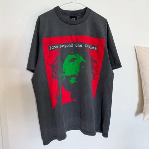 Saint Michael tee - Saint Michael ”love beyond the realms” tee.  Size XL.  Faded, cracked print, single stitch, made in Japan.  Saint Michael is a vintage-inspired streetwear brand established in 2020 by Yuta Hosokawa, the designer of READYMADE, and artist Cali Thornhill Dewitt. The brand focuses on creating unique pieces with a vintage aesthetic. 