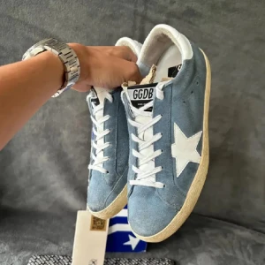 Blå sneakers från Golden Goose - Snygga blå sneakers från Golden Goose med vit stjärndetalj på sidan. Skorna har en klassisk design med snörning och en vit sula. Perfekta för en avslappnad stil.