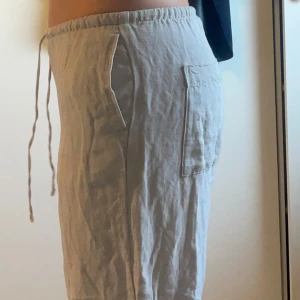Beige linnebyxor från H&M - Säljer ett par bekväma beige linnebyxor från H&M. Byxorna har en elastisk midja med dragsko och praktiska fickor på sidorna. Perfekta för en avslappnad stil.