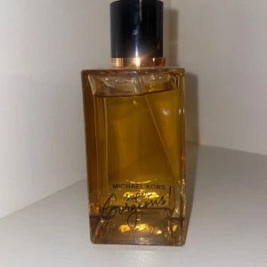 Michael Kors Super Gorgeous! parfym - Lyxig parfym från Michael Kors i modellen Super Gorgeous! Flaskan är rektangulär i genomskinligt bärnstensfärgat glas med svart och guld kork. Perfekt för dig som vill ha en elegant och modern doft på hyllan.