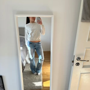 Grå croppad sweatshirt - Säljer en stilren grå croppad sweatshirt med rund hals och långa ärmar. Perfekt för en avslappnad look. Passar bra till jeans eller leggings. 