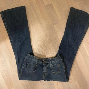 Blå bootcut jeans - Snygga blå bootcut jeans med klassisk femficksdesign. Tillverkade i en bomullsblandning med lite stretch för extra komfort. Perfekta för en avslappnad stil. Lågmidjade och utsvängda! 