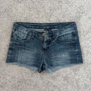 Mörkblå jeansshorts - Säljer ett par snygga lågmidjade jeansshorts som passar perfekt nu när det börjar bli varmare ute. Storlek 36. Hör av er vid frågor och funderingar!!🥰