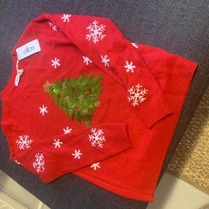 Röd jultröja med julgran från Ellos - Ny, oanvänd, prislapp kvar. Säljer för den används ej