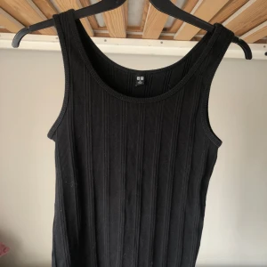 Svart ribbat linne Uniqlo - Svart ribbat linne från Uniqlo i mjuk bomull. Stretchig passform. 