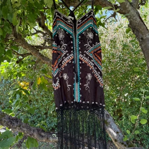 Svart boho klänning Odd Molly - Unik svart klänning från Odd Molly med färgstarka broderier i turkos, orange och vitt. Klänningen har smala axelband, omlott-detalj och långa fransar nedtill. Mönstret är geometriskt och bohemiskt, perfekt för dig som gillar statement-plagg med cool vibe. Storlek 3 som enligt deras storleksguide motsvarar en storlek L.  Mycket fint skick, jag hittar inga synliga anmärkningar eller defekter. 