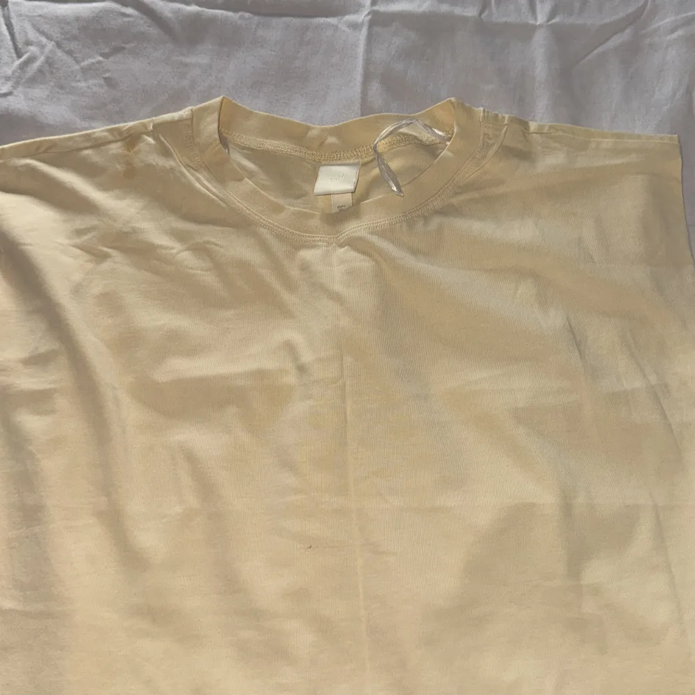 Säljer en basic Gul t-shirt från H&M. T-shirten har rund halsringning och är tillverkad i mjuk bomull. Perfekt att styla med jeans eller shorts för en enkel och clean look.. T-paidat.