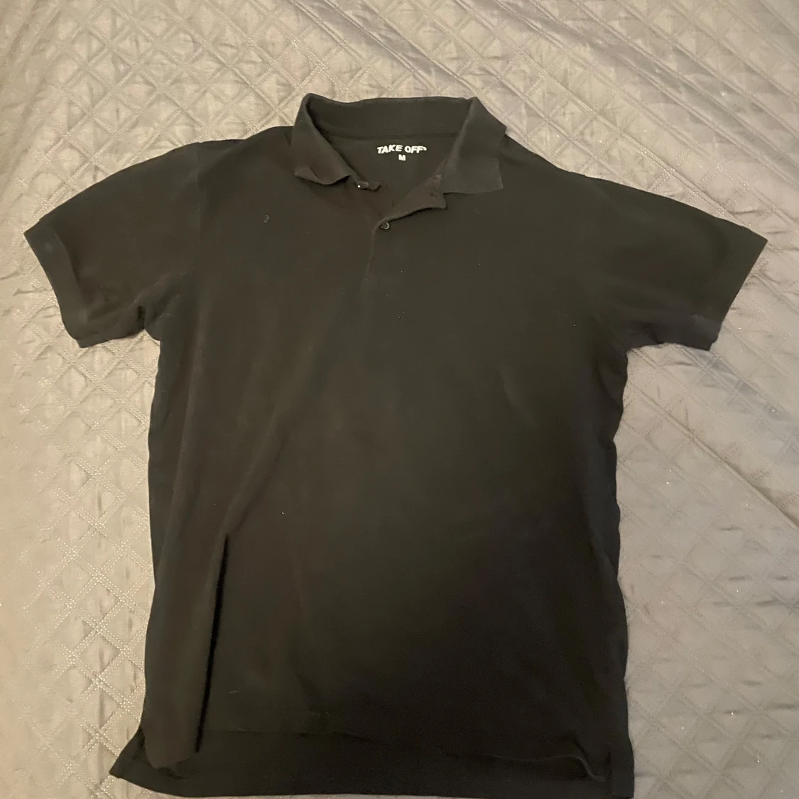 Svart pikétröja från Take Off