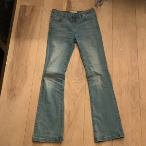 Ljusblå bootcut jeans Bailey - Säljer ett par ljusblå bootcut jeans från Bailey i storlek 164. Klassisk femficksmodell med knapp och dragkedja framtill. Jeansen har en lätt utsvängd passform nertill och är perfekta för en avslappnad stil.