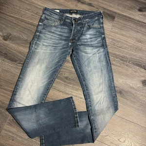 Blå slim fit jeans från Jack & Jones - Snygga blå jeans från Jack & Jones i modellen Slim Fit/Glenn. Jeansen har klassisk femficksdesign. Storlek W29 L32. Perfekta för dig som gillar en smalare passform. Priser går att ändra vid snabb affär, hör av er vid funderingar