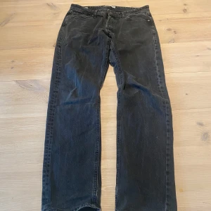 Svarta jeans från Jack & Jones - Svarta jeans från Jack & Jones med raka ben och klassisk femficksdesign. Jeansen har normal passform och är tillverkade i ett slitstarkt jeanstyg. Perfekta för dig som gillar en enkel och tidlös stil. Skicka ett meddelande för frågor, storlek, mått osv. 