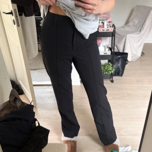 Kostymbyxor med söm - Kostymbyxor från NA-KD, raka långa ben, mid rise och en snygg kontrast söm fram 💕Storlek 34 men sitter bra på mig som brukar använda 36 🥰 Jag är 174 och byxorna sitter perfekt i längden på mig 😊 I fint skick, Använd gärna köp nu!