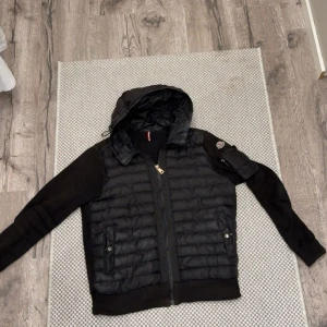Svart pufferjacka med huva från Moncler - Säljer en snygg moncler cardigan för bra pris 