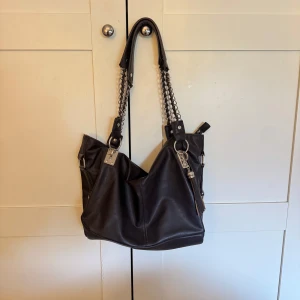 Handväska - Snygg unik brun väska med kedjedetaljer!! Säljer då den tyvärr aldrig kommer till användning!🤎 (Aldrig använd)