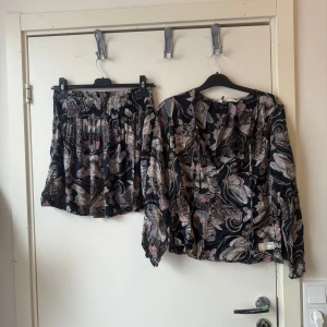 Odd molly det med blus och kjol  - Säljer ett snyggt set med blus och kjol med massa färger  i svart. Det finns också en superfint ljuärilsmömster i färgerna grå, beige, lila, rosa och svart. De har normal passform, resår i midjan och snörning framtill. Perfekta för sommaren och ger en cool boho-vibe. Från märket Odd Molly i storlek 0 som enligt storleksguide motsvarar en XS. Mycket fint skick, jag hittar inga synliga anmärkningar eller defekter. 