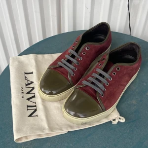 Lanvin skor - Snygga skor från Lanvin i vinröd mocka med olivgröna lackdetaljer på tån och runt kanterna. Storlek 43. Använda fåtal gånger därför är dom i mycket bra skick. Säljer pga att storleken ej passade. Köpta nyligen av min polares resell konto för 2500! Säljer nu för riktigt bra pris!