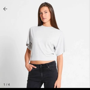 Vit croppad t-shirt - Säljer en stilren vit croppad t-shirt med korta ärmar. Perfekt för en avslappnad look. Passar bra till jeans eller kjol. Aldrig använd 
