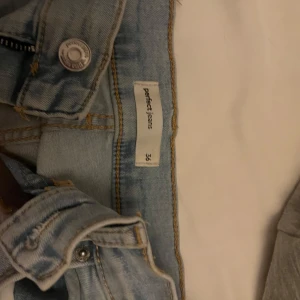 Ljusblå jeans från Perfect Jeans - Säljer ett par ljusblå jeans från Perfect Jeans i storlek 36. De har en klassisk femficksdesign och är i bra skick. Perfekta för vardagsbruk och kan matchas med nästan vad som helst. Passformen är tight och de har en snygg tvättad look.