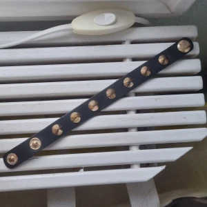 Svart armband med nitar på - Snyggt svart armband med guldiga nitar på. Säljer då de inte kommer till användning💞