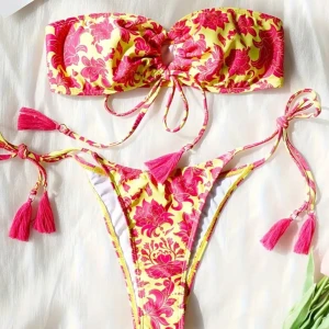 Gul och rosa blommig bikini - Trendig bikini i gult och rosa med blommigt mönster. Bandeau-topp med knytband och tofsdetaljer. Matchande trosa med knytband i sidorna 💖💖💖OVANVÄND!🥰
