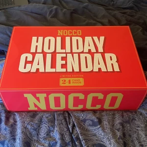 NOCCO Holiday Calendar - Säljer en NOCCO Holiday Calendar, en limited edition adventskalender med 24 burkar. Perfekt för att räkna ner dagarna till jul med en ny smak varje dag. Kalendern är röd med stora vita bokstäver och gulddetaljer. En rolig och energifylld överraskning för december! Väldigt svår att få tag i så unna er och köp en💪🏼priset går självklart att diskutera, våga lägg ett bud👌🏼👌🏼