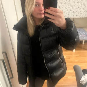 Massimo Dutti dunjacka - Svart dunjacka från Massimo Dutti. Den är använd ett förtal gånger och är i storlek M. Luvan har en dragkedja och man kan välja själv om man vill ta av den eller inte💗