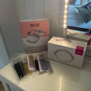 Nagelkit - Säljer mina nagelgrejer då jag tappat intresset. Säljer helst allt i ett kit för 1200 kr men det går att köpa en separat också 😇Elektrisk nagelfil från nailster, nypris 1299 kr (separat 800 kr). UV-lampa från nagelgiganten, nypris 499 kr (separat 200 kr). Penslar & verktyg, oanvända (separat 200 kr). Tipparna, kudden och glittret på andra bilden ingår vid köp av en produkt (om man vill). *Bilden från nailsters hemsida är en nyare variant än den jag säljer, men priset var detsamma när jag köpte!