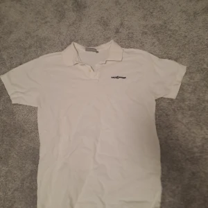 Vit pikétröja från Race Marine - Säljer en klassisk vit pikétröja från Race Marine i storlek L. Tröjan har korta ärmar och en stilren krage. Perfekt för en avslappnad men ändå snygg look. Passar bra till både vardag och lite finare tillfällen. 🏖️