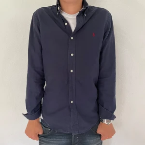 Ralph lauren skjorta mörkblå   - Säljer nu en snygg  skjorta ifrån  Ralph Lauren.  storlek S slim fit. Den är i fint skick 