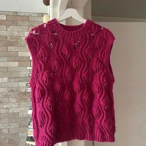 Stickat linne - Helt oanvänd stickat linne i fuchsiarosa färg. 56 cm i längd, 48 cm i bredd