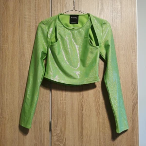 (S) Grön glansig glittrig topp från Bershka - Snygg grön långärmad glittrig topp från Bershka med öppen rygg. Glittriga punktprickar som skapar en skimrande effekt 🥰