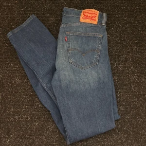 Levi's 511 jeans - Säljer ett par klassiska Levi's 511 jeans i blå denim. De är i en slim passform och har den ikoniska Levi's-lappen på baksidan. Perfekta för både vardag och fest!