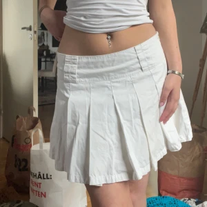 Vit kjol från Bik Bok - Säljer en superfin vit kjol från Bik Bok i storlek M. Kjolen har en klassisk design med veckade detaljer som ger en snygg och stilren look. Den är definitivt redo för nya äventyr! 