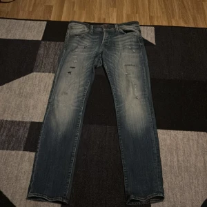 Blå slim jeans med slitningar - Säljer ett par jack and jones jeans med slitningar då jag växt ur dom strl 32/34 men passar 31/32 eller 32/32 mycket bättre. Skriv gärna vid funderingar👍