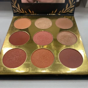 Athena ögonskuggspalett från Laritzy Cosmetics - Snygg ögonskuggspalett med nio olika nyanser från Laritzy Cosmetics. Paletten heter Athena och har en mix av matta och skimrande färger som Hero, Goddess och Ares. Perfekt för att skapa både vardagliga och dramatiska looks.