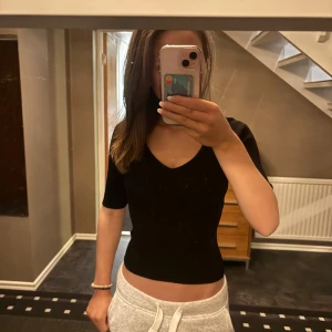 Svart v-ringad topp - Säljer en stilren svart v-ringad topp i mycket bra skick.