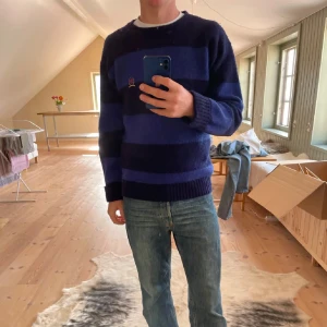 Tommy hilfiger tröja - Säljer en snygg blå och svart randig tröja med långa ärmar. Den är i bra skick och inte så använd!
