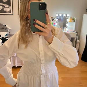 Vit skjorta från only - Säljer en stilren vit skjorta från Only med långa ärmar och knappar framtill. Skjortan har en smockdetalj i midjan som ger en snygg passform. Perfekt för en chic look!