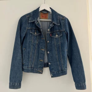 Jeansjacka från Levi's - Mycket bra skick, princip som ny! Säljer pga för liten   Supersnygg jeansjacka från Levis i strl XS. Jättefin mörkblå färg , normal i storlek.  Pris kan diskuteras!