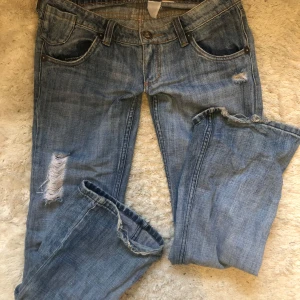 Lowwaist bootcut jeans - Jätte snygga low waist bootcut jeans med detaljer på fickorna, lite slitna nere vid foten på byxan men annar i superbra skick