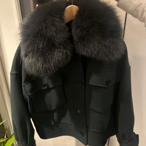 Meotine jacka grön - Säljer världens snyggaste kappa i den perfekta gröna färgen. Ärmarna går att vika upp om man skulle vilja det och pälsen är avtagbar. Köpte denna för två år sedan och har älskat allt med den.  Storlek M/L Äkta räv päls