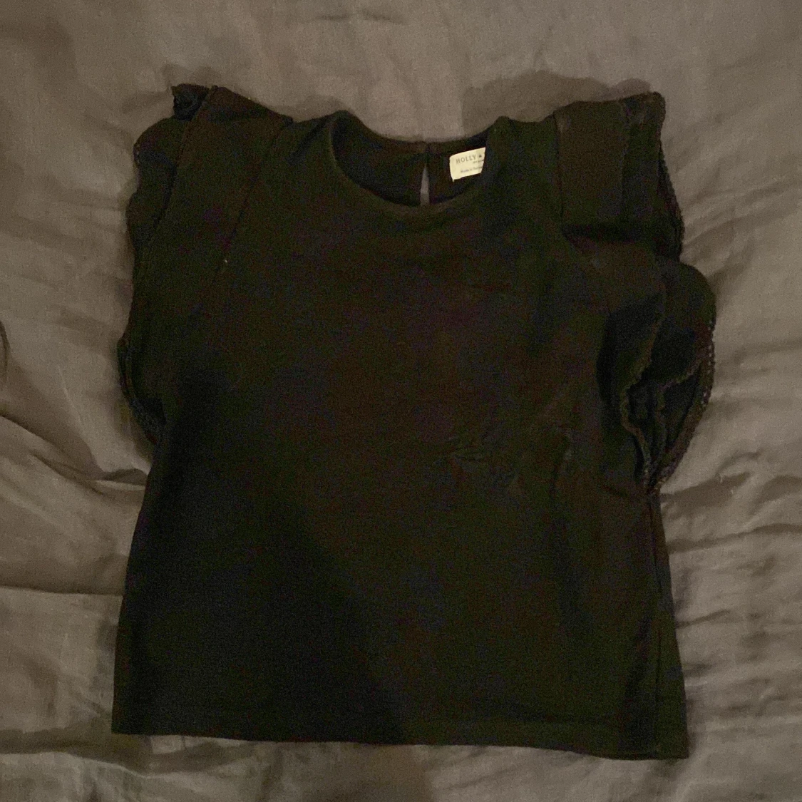 Svart topp med volangdetaljer - 90