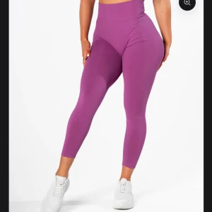 Radiant scrunch - neon purple - Snygga lila leggings med hög midja och tight passform. Perfekta för träning eller en avslappnad dag. De är tillverkade i ett stretchigt material som ger bra rörelsefrihet.