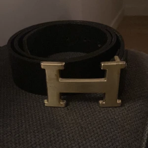 Svart bälte med guldfärgat spänne - Jag vill byta skärpet mot ett lika dant fast med silver-H eller något annat bättre.
