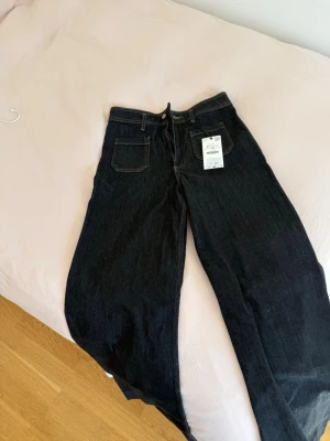 Mörkblå jeans - Mörkblå jeans i bredare modell, högmidjade - storlek 40 men små i storleken. Aldrig använda, prislappen kvar. Kolla gärna in mina andra annonser så samfraktar jag! Skicka gärna prisförslag 🫶🏼