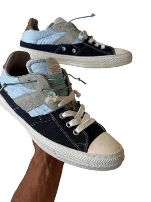 Maison Margiela Evolution 2 in 1 hybrid low top sneaker  - Size: EU 44 (US 10-11 mens)  Sole Height: ~1.2” Sole Length: ~11.8”  This authentic Maison Margiela Evolution sneaker is a standout example of the label’s ongoing dialogue between sportswear and conceptual fashion. The 2-in-1 hybrid construction in cotton and nylon reflects Margiela’s interest in material experimentation, while the blue colorway gives the silhouette a clean, collected edge rooted in the label’s minimalist design philosophy.  Condition: Some signs of wear consistent with prior us